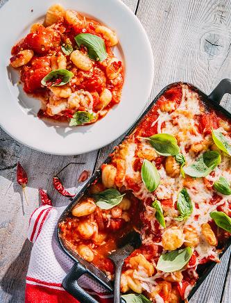 Image of Baked Gnocchi in a Pomodoro Sauce made with Tuttorosso Tomatoes in a casserole dish and on a white plate