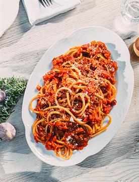 Image of pasta with red sauce on white platter